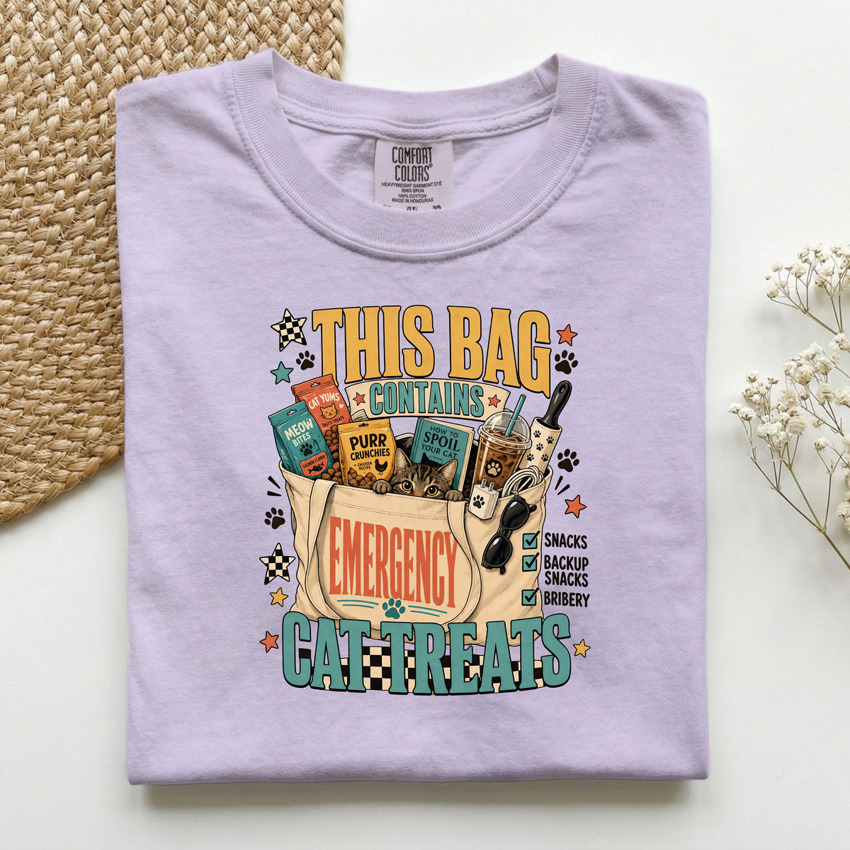 This Bag Contains Emergency Cat Treats graphic tee in Orchid, folded flat lay