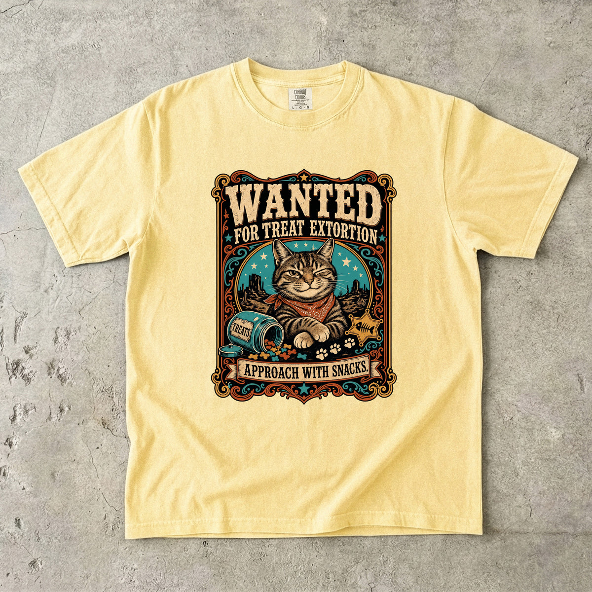 Wanted For Treat Extortion graphic tee in Butter, folded flat lay