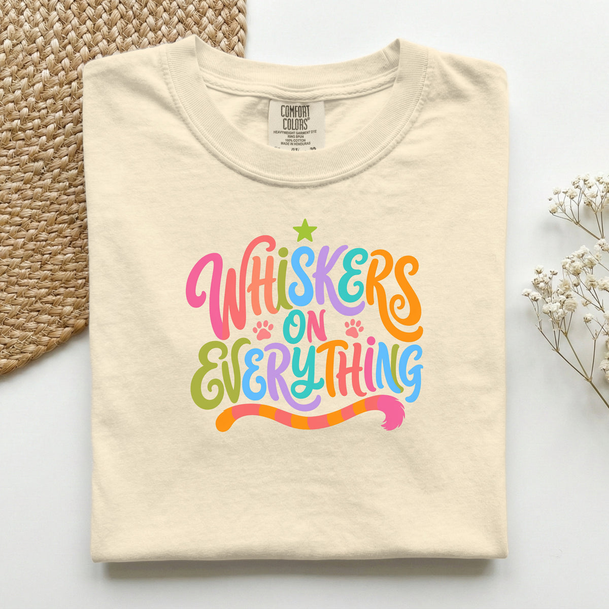 Whiskers On Everything graphic tee in Ivory, folded flat lay