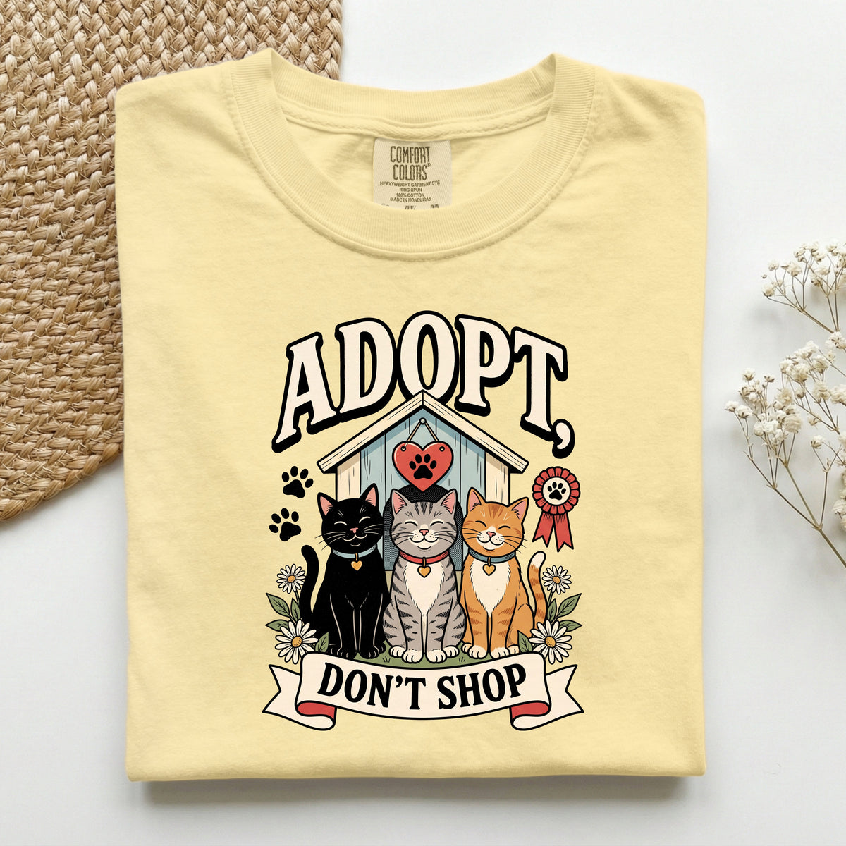 Adopt, Don't Shop graphic tee in Butter, folded flat lay