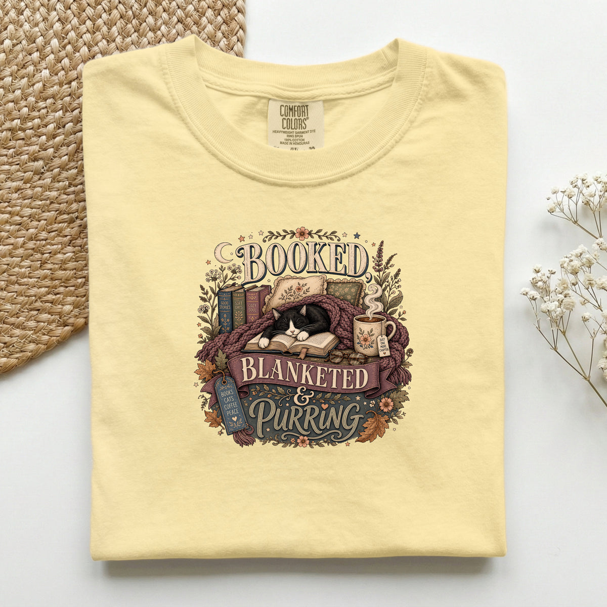Booked Blanketed And Purring graphic tee in Butter, folded flat lay