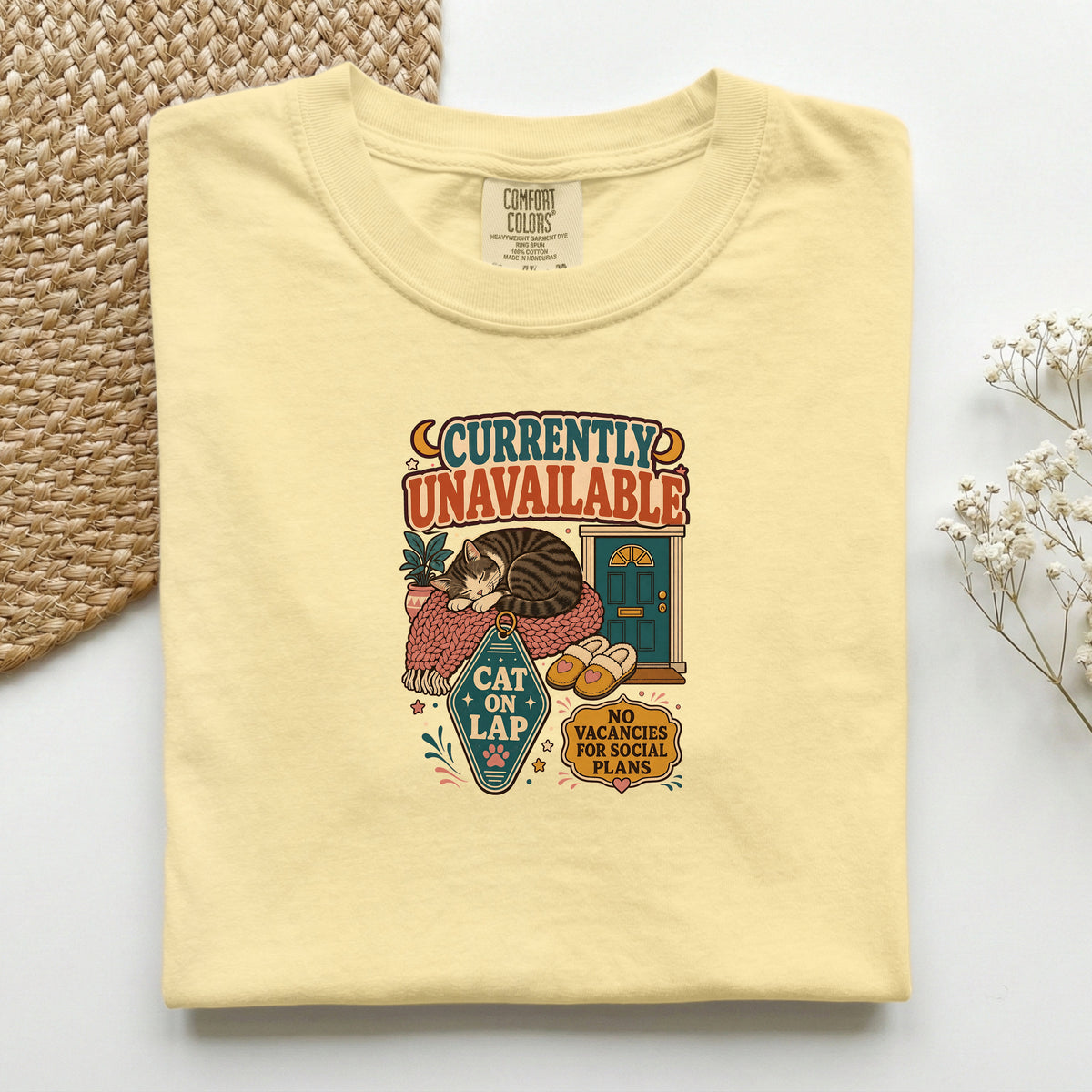 Currently Unavailable, Cat on Lap graphic tee in Butter, folded flat lay