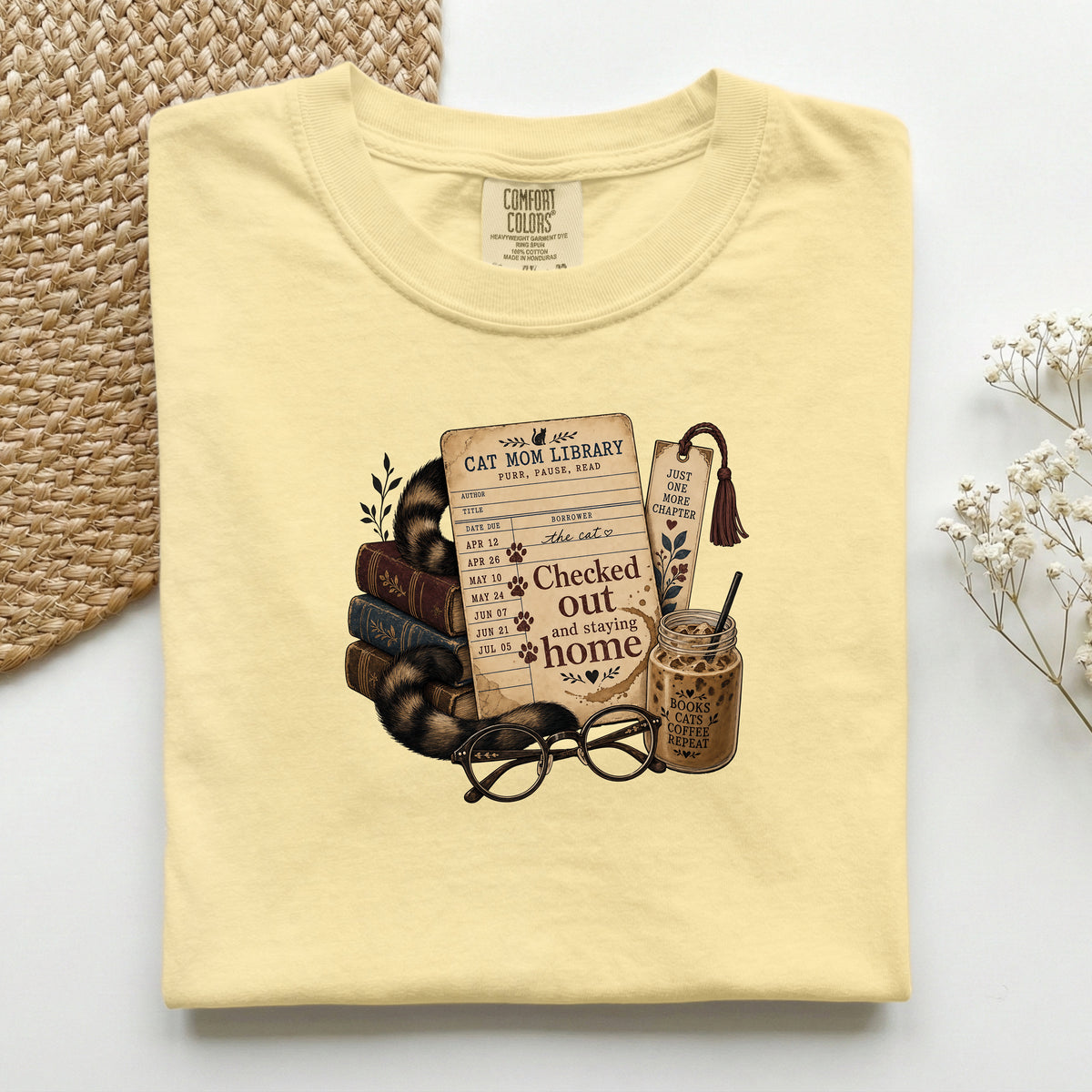 Cat Mom Library graphic tee in Butter, folded flat lay