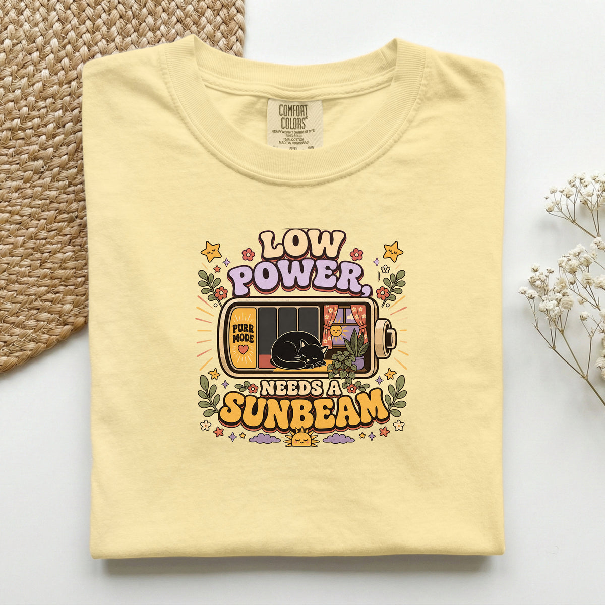 Low Power, Needs a Sunbeam graphic tee in Butter, folded flat lay