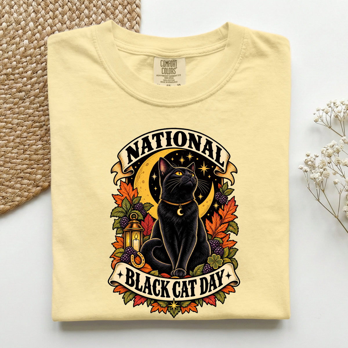 National Black Cat Day graphic tee in Butter, folded flat lay