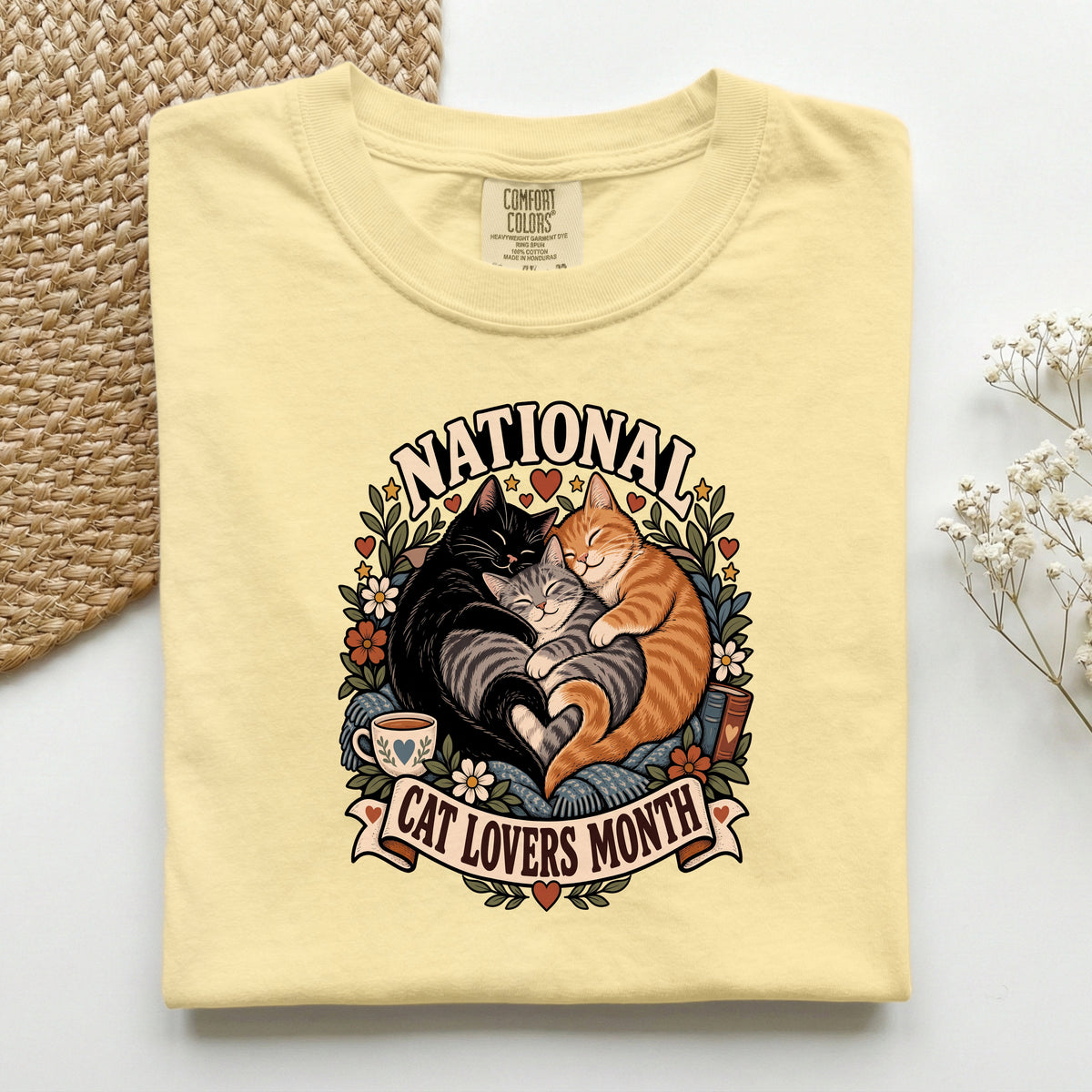 National Cat Lovers Month graphic tee in Butter, folded flat lay