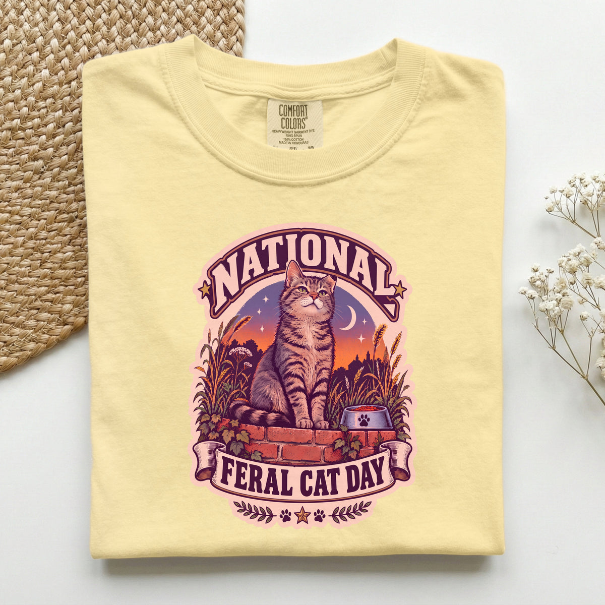 National Feral Cat Day graphic tee in Butter, folded flat lay