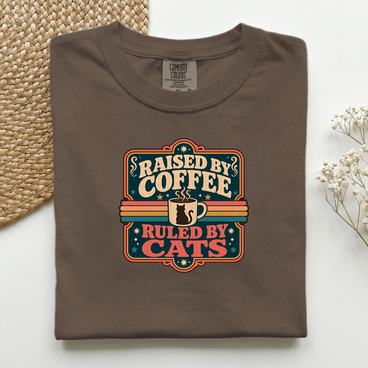 Raised By Coffee Ruled By Cats graphic tee in Espresso, folded flat lay