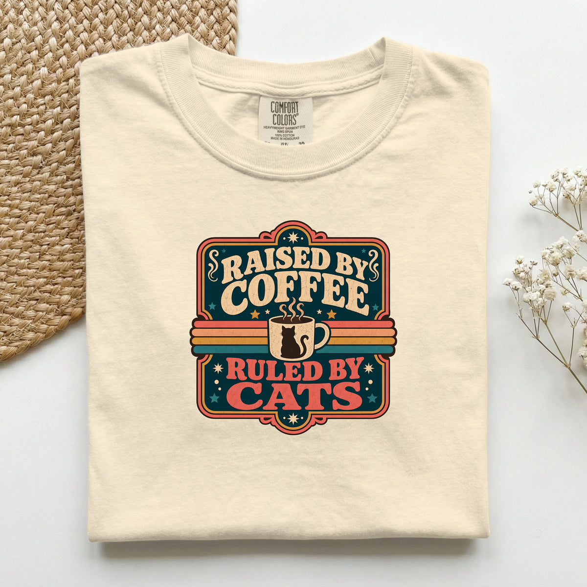 Raised By Coffee Ruled By Cats graphic tee in Ivory, folded flat lay