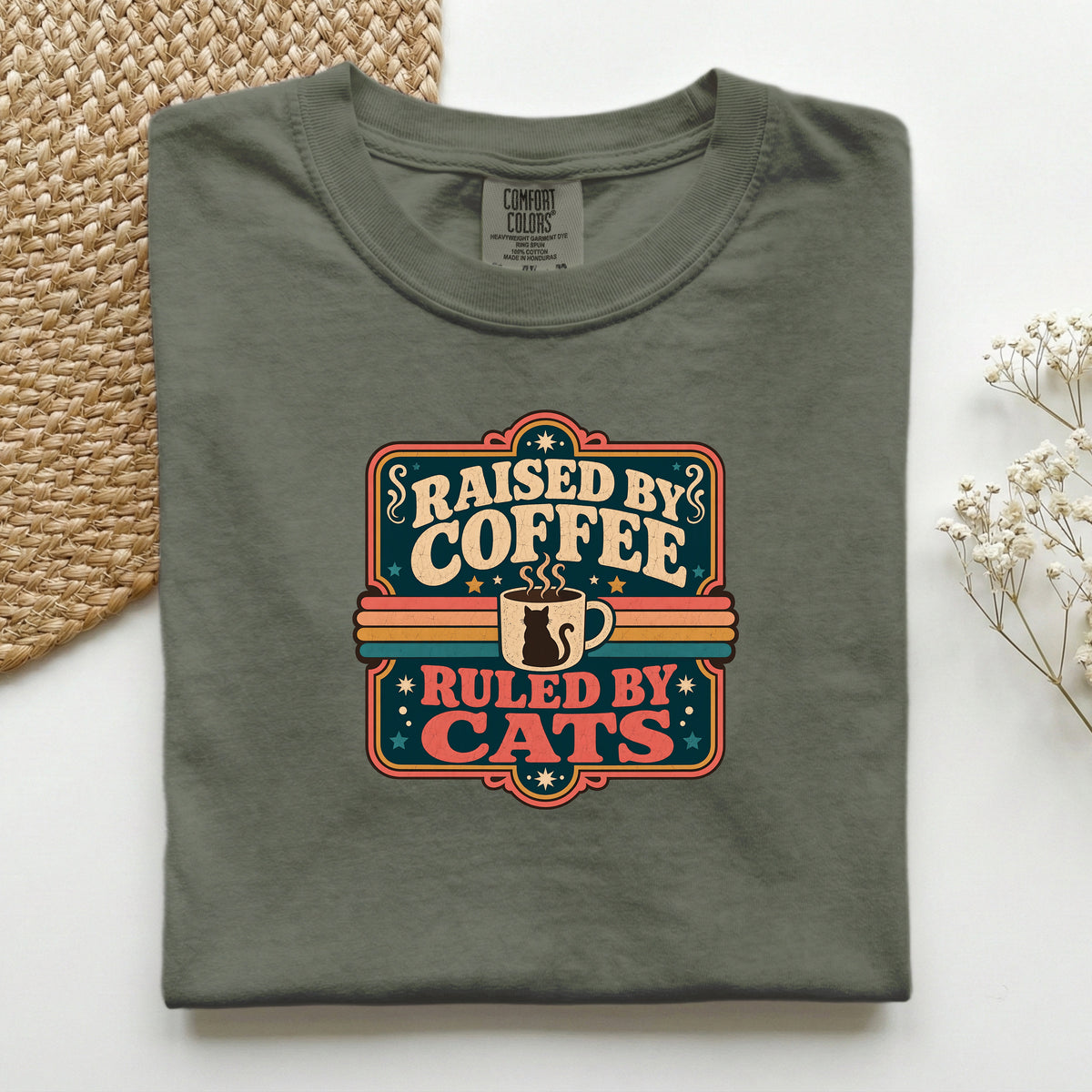 Raised By Coffee Ruled By Cats graphic tee in Moss, folded flat lay