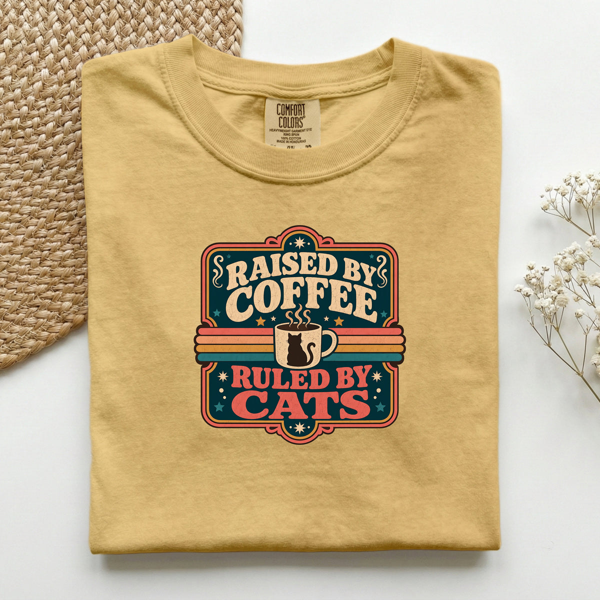 Raised By Coffee Ruled By Cats graphic tee in Mustard, folded flat lay