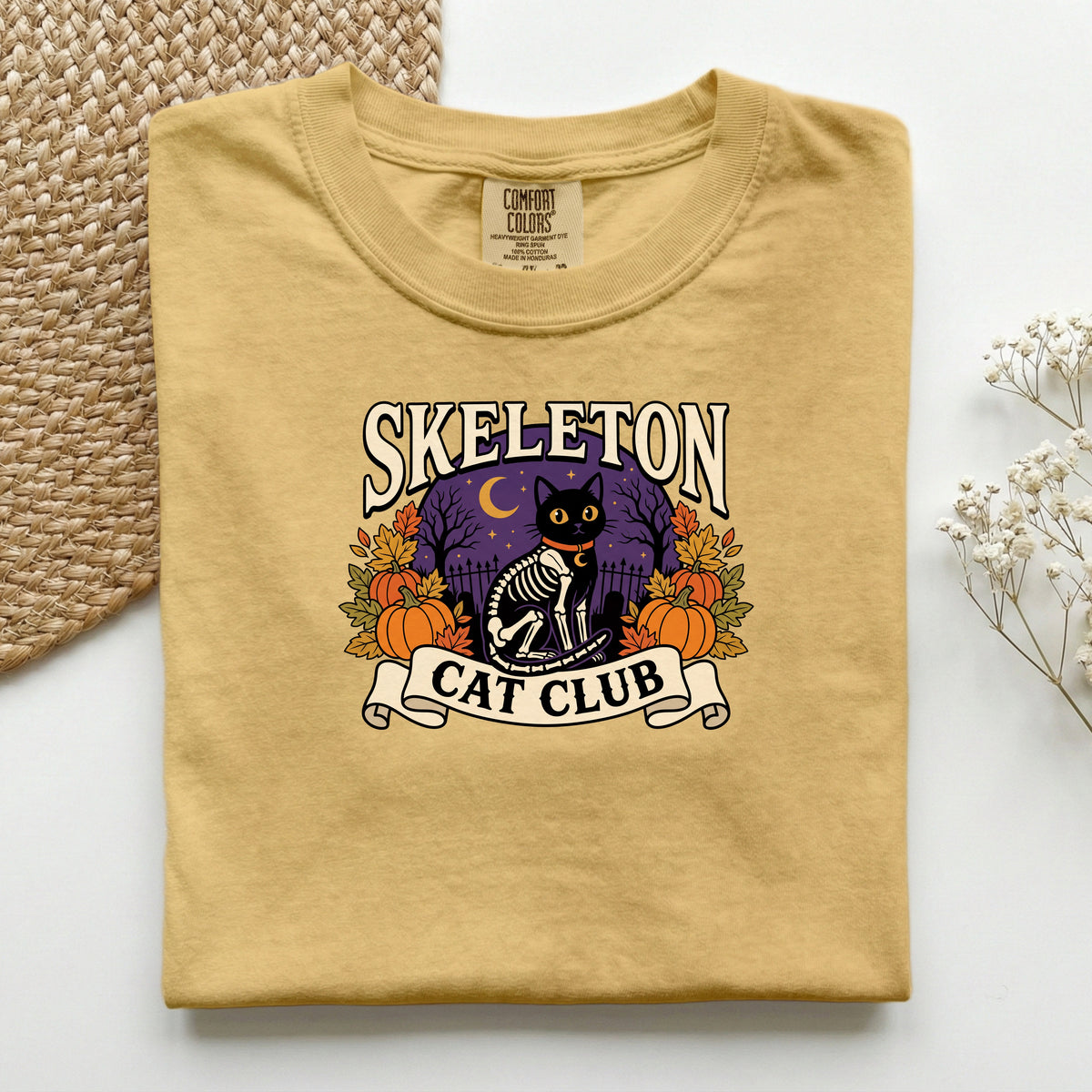 Skeleton Cat Club graphic tee in Mustard, folded flat lay