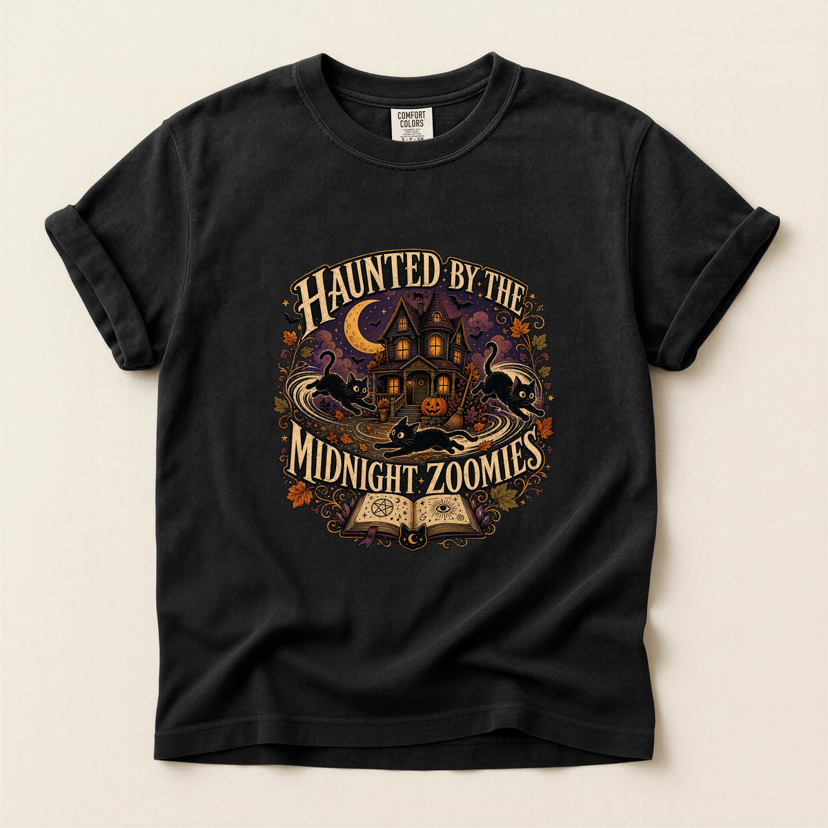 Haunted By The Midnight Zoomies graphic tee in Black, folded flat lay
