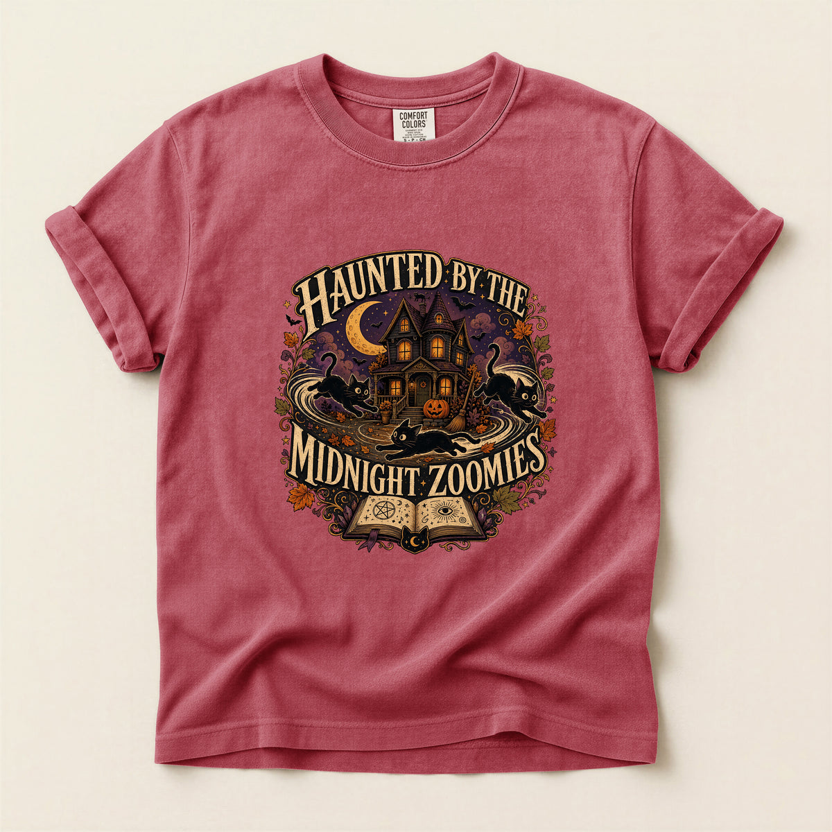 Haunted By The Midnight Zoomies graphic tee in Crimson, folded flat lay