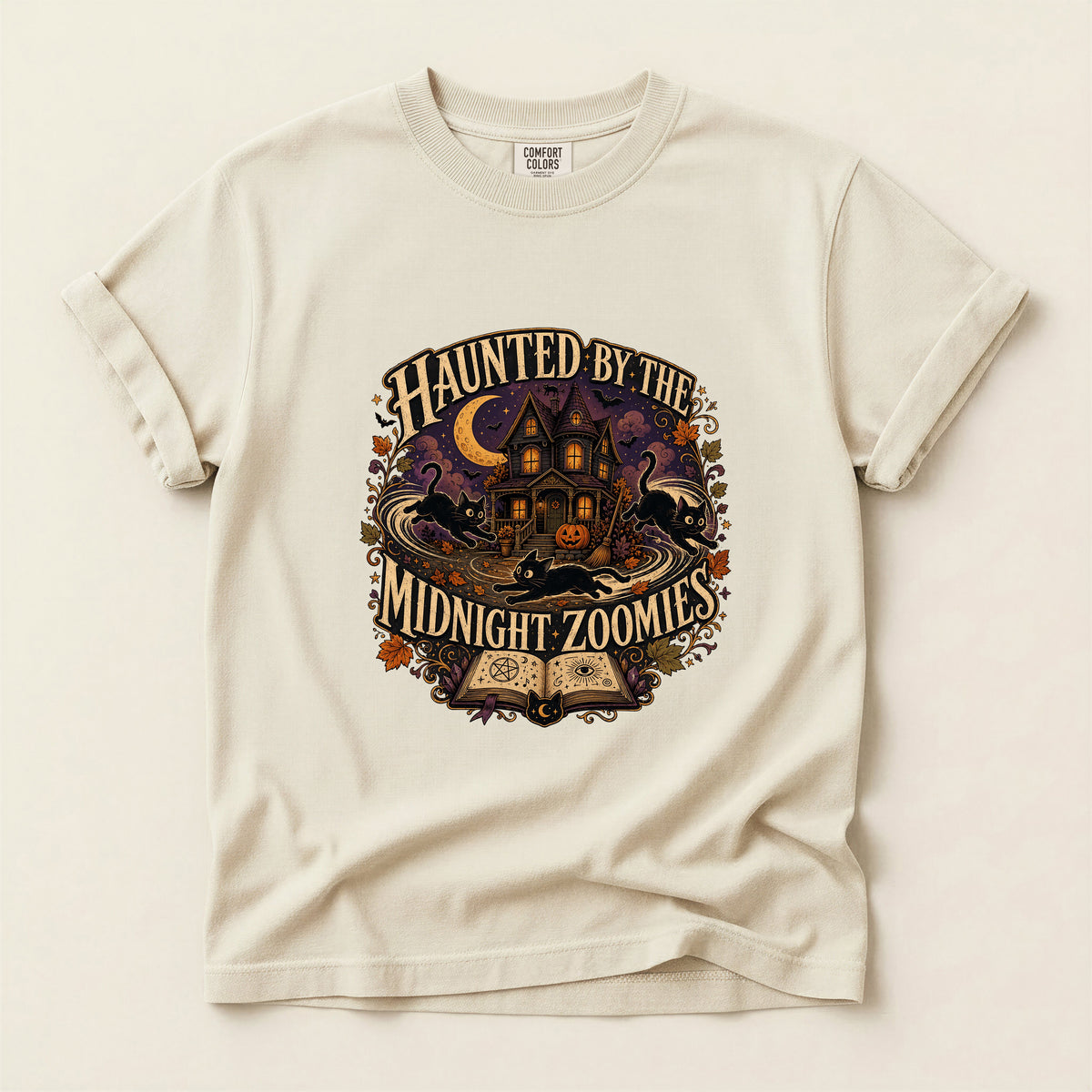 Haunted By The Midnight Zoomies graphic tee in Ivory, folded flat lay