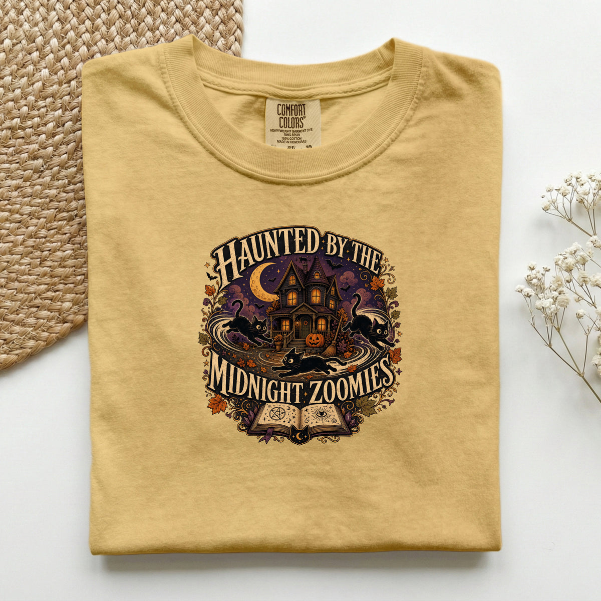 Haunted By The Midnight Zoomies graphic tee in Mustard, folded flat lay